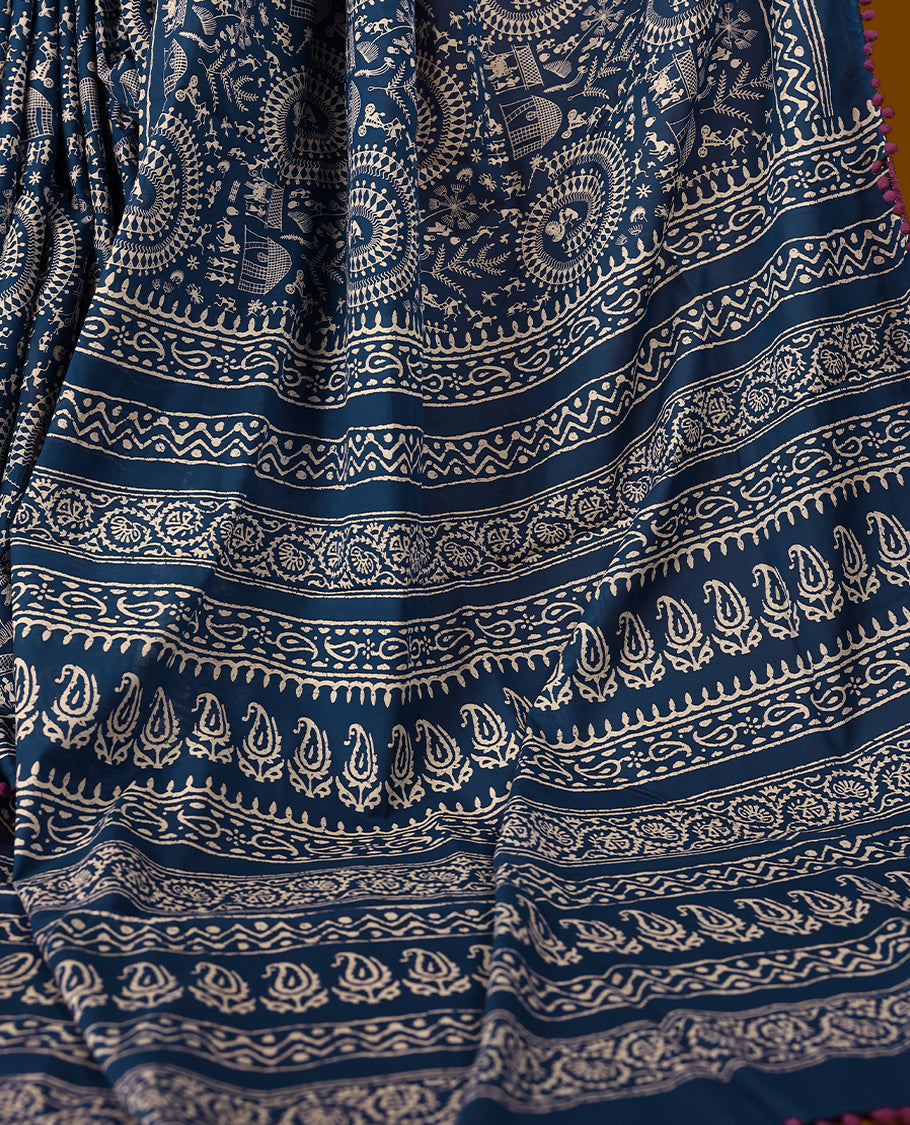 Blue cotton saree features intricate off-white handblock prints, a beautifully detailed border with Grape piping and Self Coloured Blouse