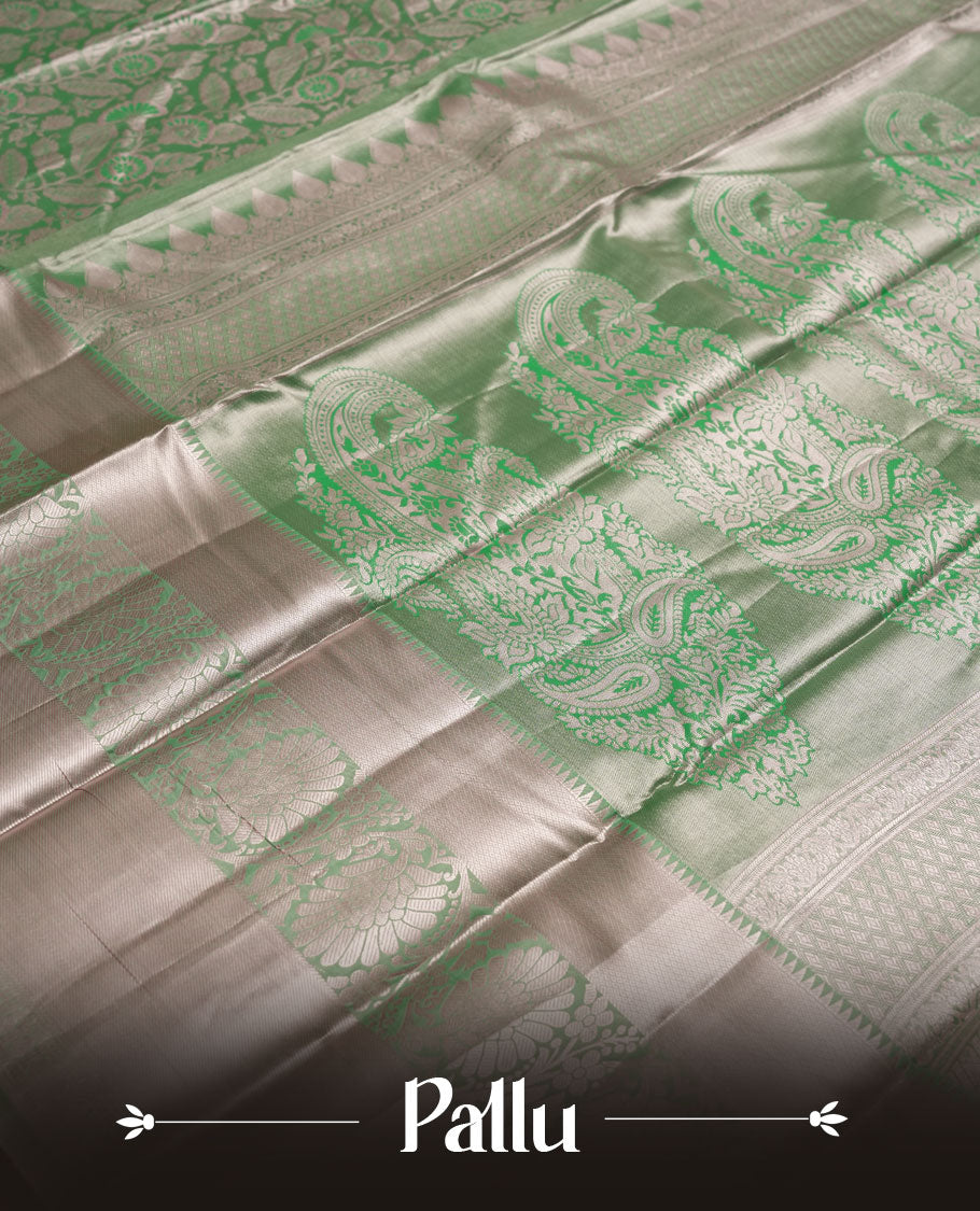Pastel green colour and Antique gold Zari Tissue Brocade Saree features intricate floral Motifs on body and light rose gold border & pallu with floral patterns, paired with matching blouse