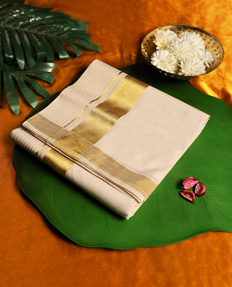 Elegant off white colour pure handloom cotton double dhoti in fine cotton, featuring a broad golden zari border with sleek parallel lines, crafted for timeless traditional charm and festive wear.