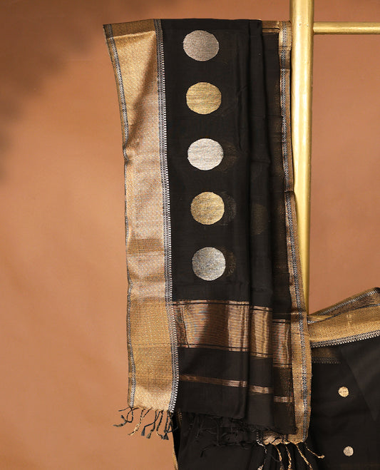 Pure Black colour Maheshwari Cotton saree featuring Antique Zari bindi Patterns across the entire body, complemented by a traditional Gold Zari border & Pallu, with a matching blouse.