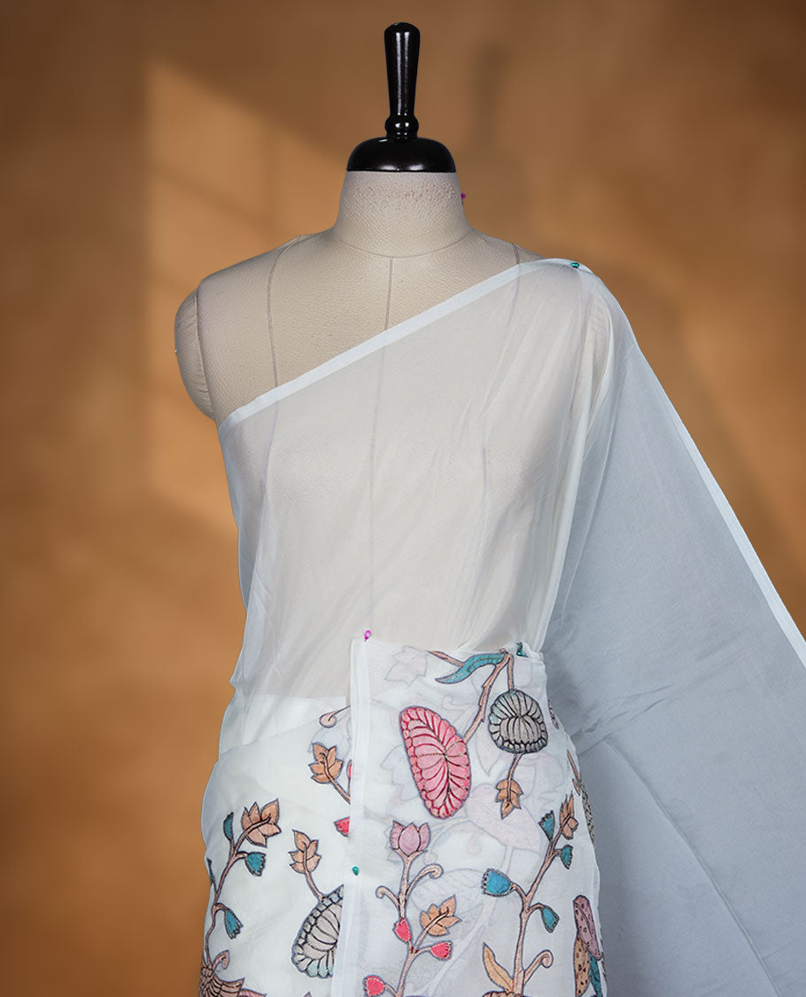 Ivory white colour organza saree featuring multicolour floral and bird printed motifs on the pallu with a subtle fine border, paired with a matching printed blouse.