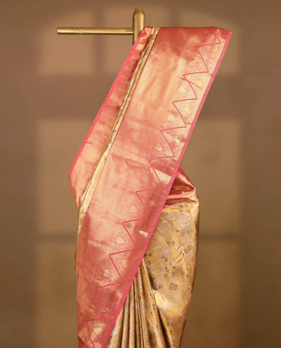 Gold colour tissue brocade saree with gold and silver zari floral pattern on body, gold zari traditional Piramide & thilakam work Blush Pink border, rich matching pallu with Antique zari motifs, paired with matching blouse.