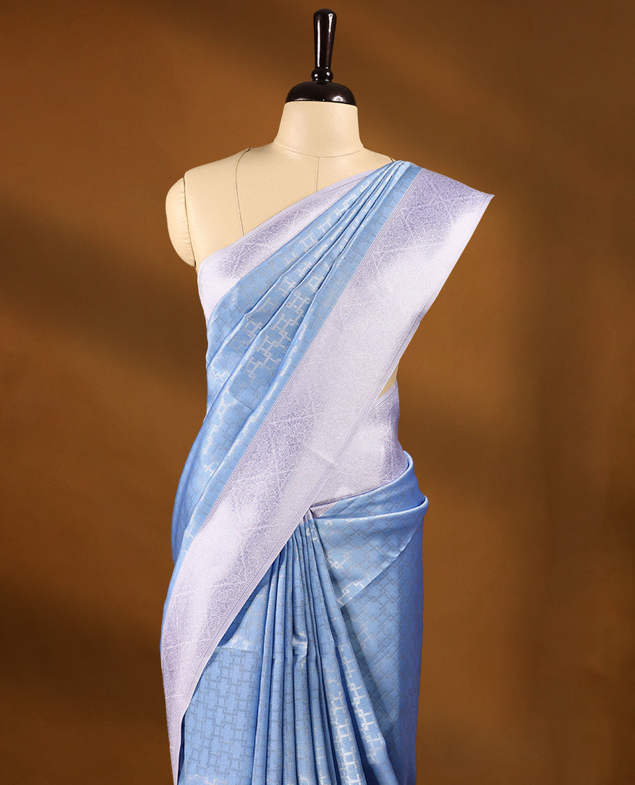 Pastel Blue coloured semi silk saree featuring a Silver coloured Zari design on the body, paired with a Lavender coloured border and blouse.