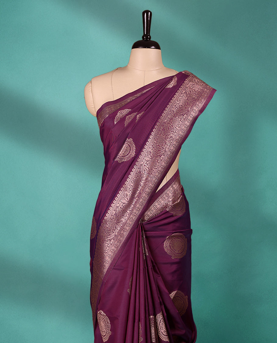 Grape Wine coloured semi silk saree featuring a Golden Zari Butta design on the body, paired with a Self coloured border and matching blouse.