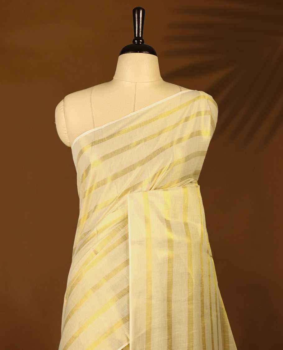 Light Gold colour Tissue Kerala saree featuring Gold zari Striped body, with Olive Green colour tassels with a matching blouse perfect for festive occasions.