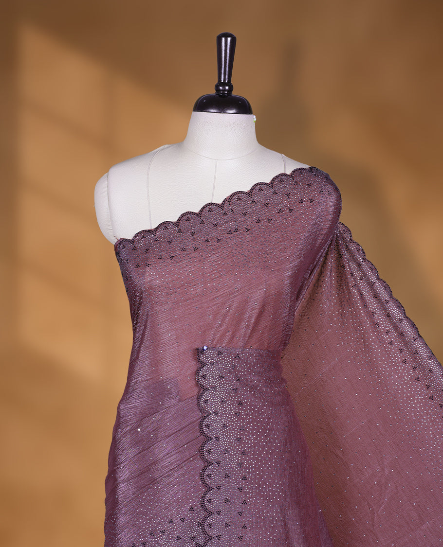 Grape colour chiffon designer saree, featuring black and white scattered stone on body, stone work and heavy stone pattern on border and pallu, Paired with matching blouse.