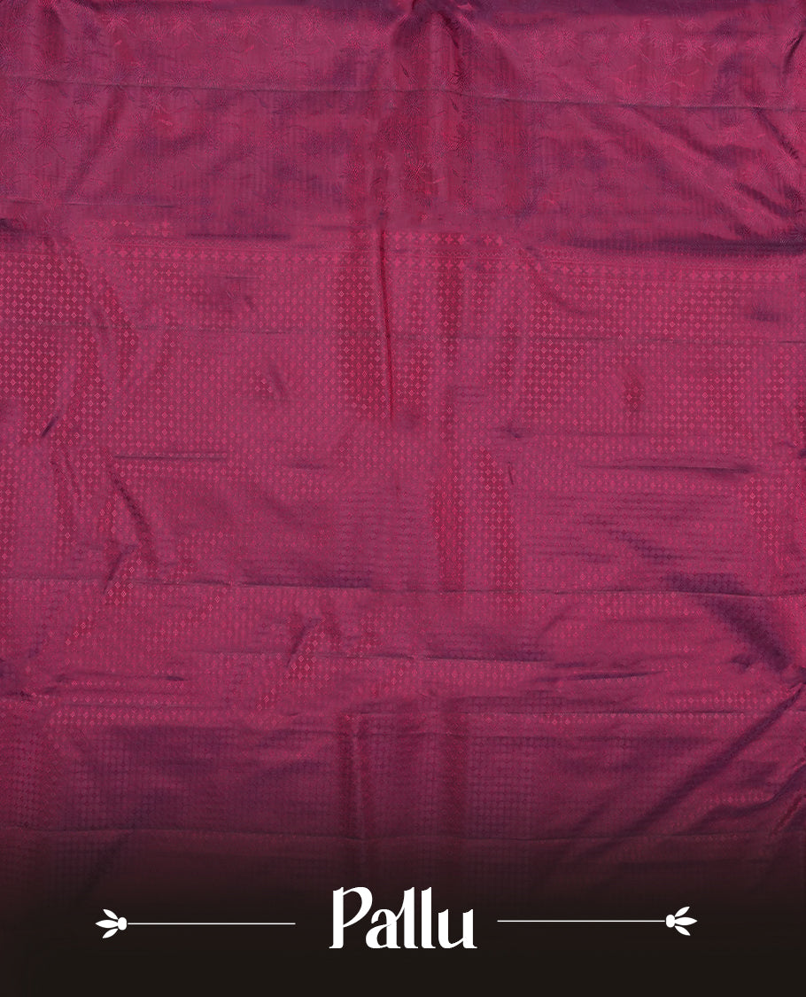 Wine colour semi soft silk saree featuring a self coloured textured patterned body, complemented by self coloured motifes on pallu & border and a matching blouse piece.