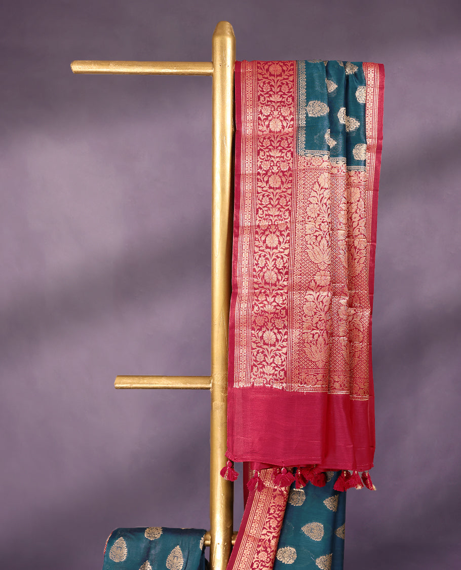 German Blue colour pure Banarasi Chanderi cotton fabric, featuring traditional antique zari buttas on the body, complemented by a traditional Rani Pink Colour border and a matching blouse.