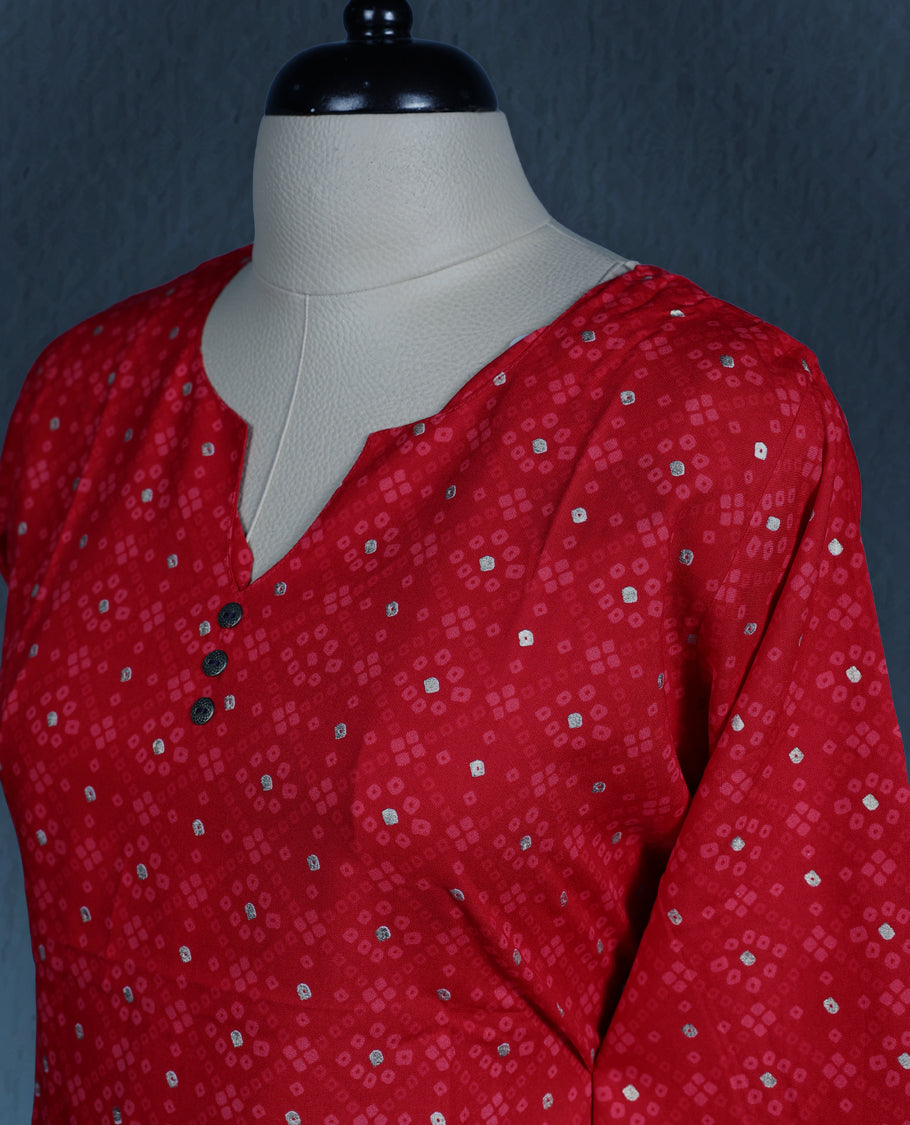 Red colour kurti adorned with an all over small geometric print, styled with a chic notch neckline enhanced by delicate button detailing, and finished with comfortable three quarter sleeves
