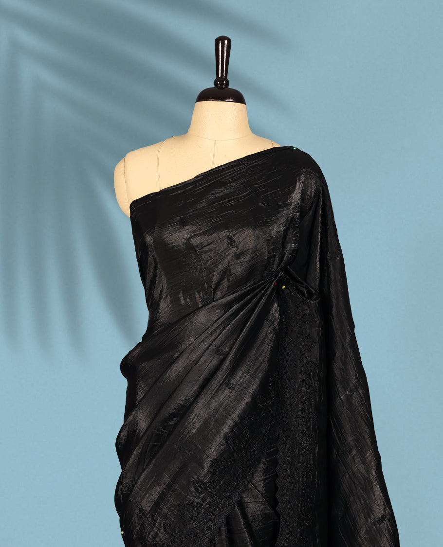 Black Colour crush soft silk saree, textured body with a natural crinkled finish, adorned with intricate self colored floral Motifs and complemented by a delicate thread embroidery cutwork border, paired with a matching blouse