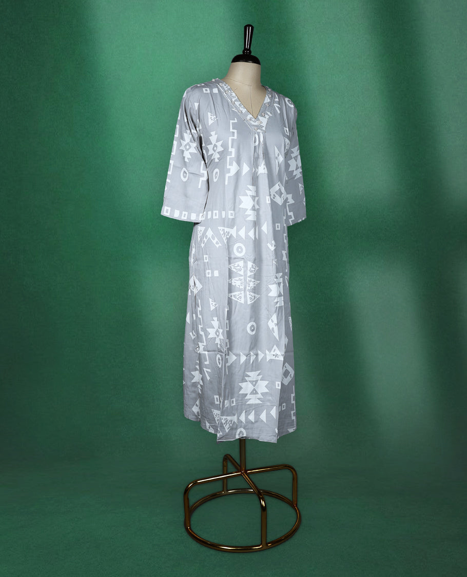 Light grey colour kurti featuring white tribalinspired geometric prints, styled with a V neckline adorned with subtle thread embroidery and 3/4th sleeves ideal for a contemporary ethnic look.