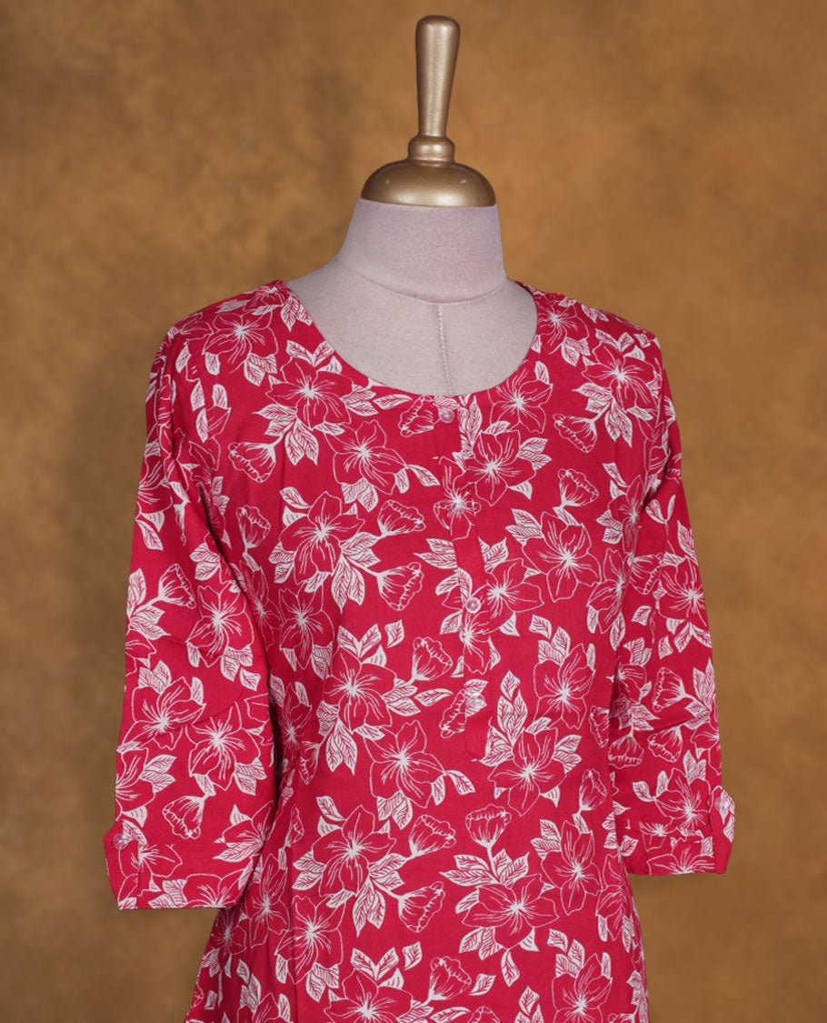 Red colour kurti with white floral prints, knee length design, styled with a round neckline and a 3/4 sleeve .