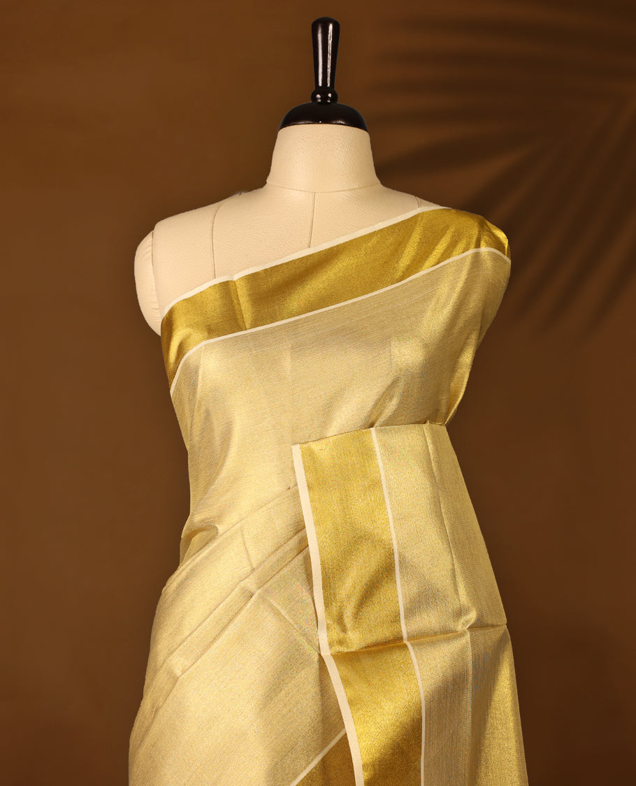 Gold colour Tissue Kerala saree featuring Plain body and a beautifully woven Gold Kasavu border, paired with a matching blouse perfect for festive occasions.