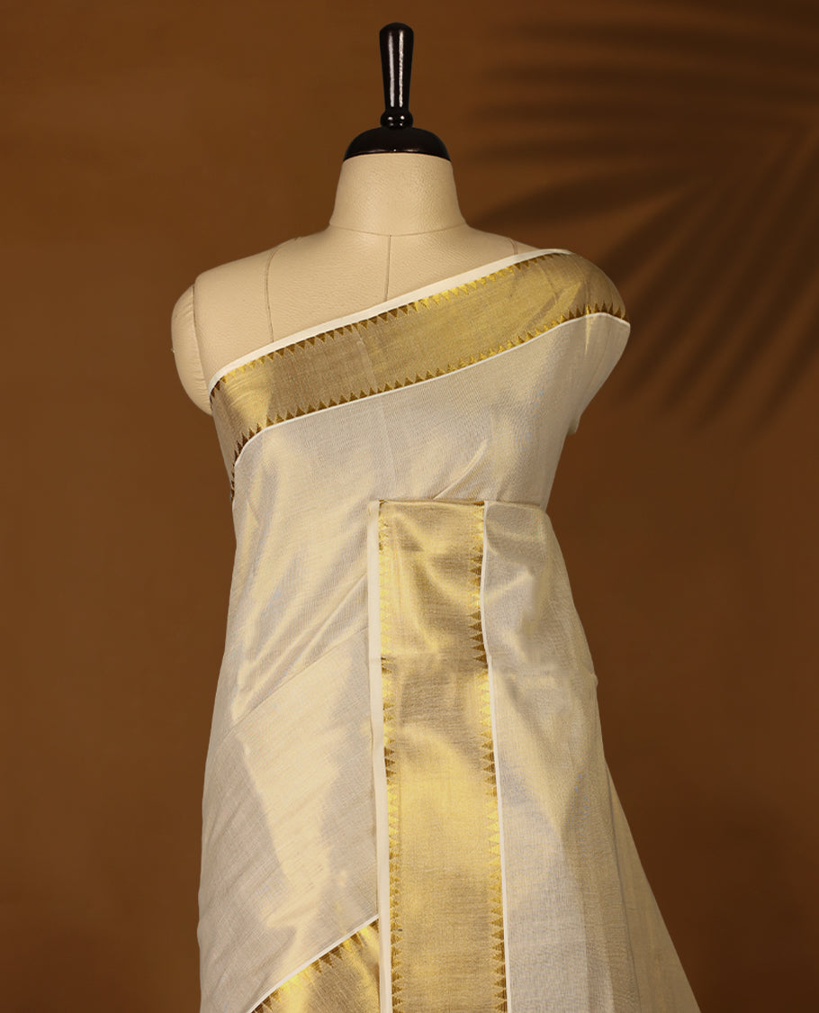 Elegant Light Gold colour Tissue Kerala saree featuring Plain body and traditional golden zari kasavu border offering a classic and graceful look, paired with a matching blouse.