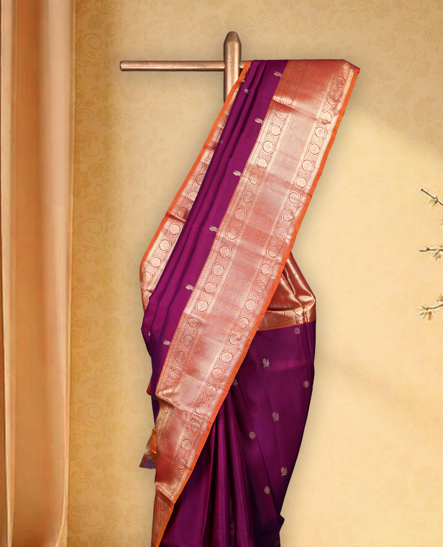 Wine colour pure Kancheepuram saree with gold zari small Mayoora chackara motifs on the body traditional contrast border with floral kodi motifs grand gold zari woven pallu paired with contrast matching blouse