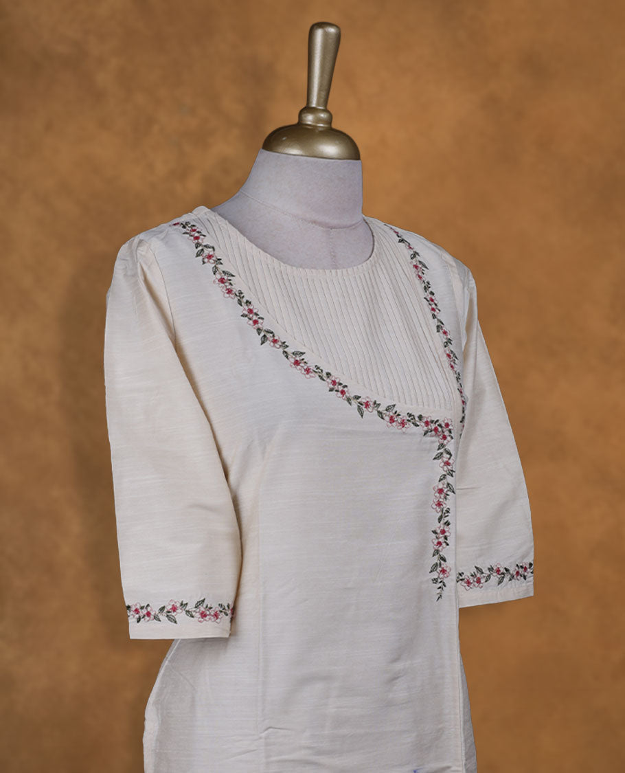 Cream colour kurti with multicolour floral thread pattern, knee length design, styled with a round neckline and a sleeve .