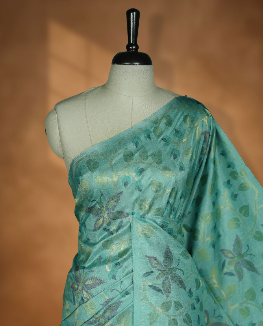 Mint colour semi tussar saree featuring woven Floral kodi & butterfly motifs on the body, complemented by a self colour without border pallu, paired with a matching blouse.