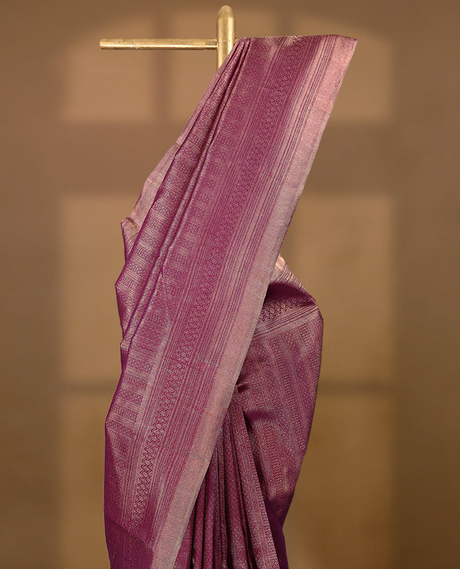 Grape wine Colour Manthrakodi saree featuring an antique zari brocade body, complemented by a self coloured traditional border and a matching self coloured brocade blouse.