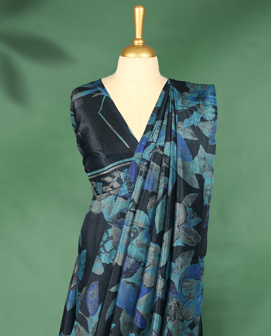 Charcoal black colour Manipuri saree featuring oversized teal and indigo floral motifs, finished without a border, and paired with a matching blouse.