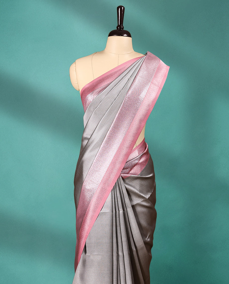Silver coloured semi silk saree featuring a Self Coloured Check design on the body, paired with a Pastel Onion coloured border and matching blouse.