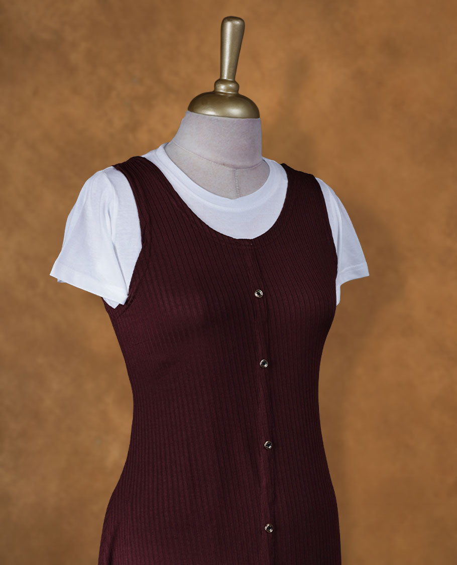 Wine maroon sleeveless A-line midi dress with front button detailing, layered over a white crew-neck short-sleeve inner tee