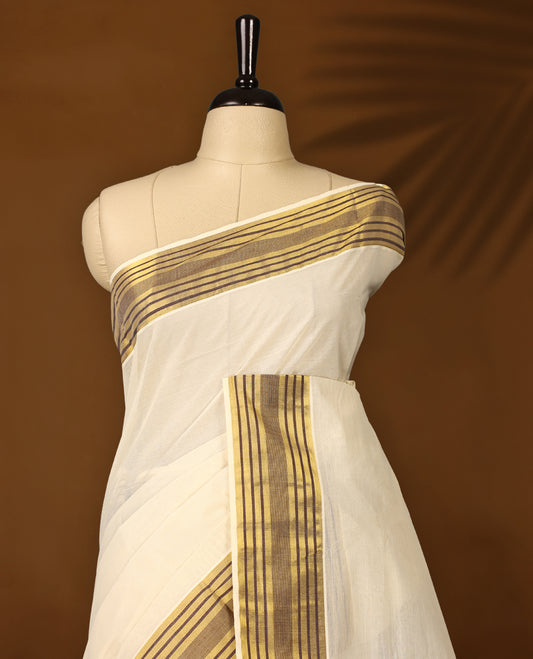 Classic off white colour Kerala cotton saree with rich brown and gold striped border, Lightweight and breathable, it comes with a matching blouse & perfect for traditional functions and everyday elegance.