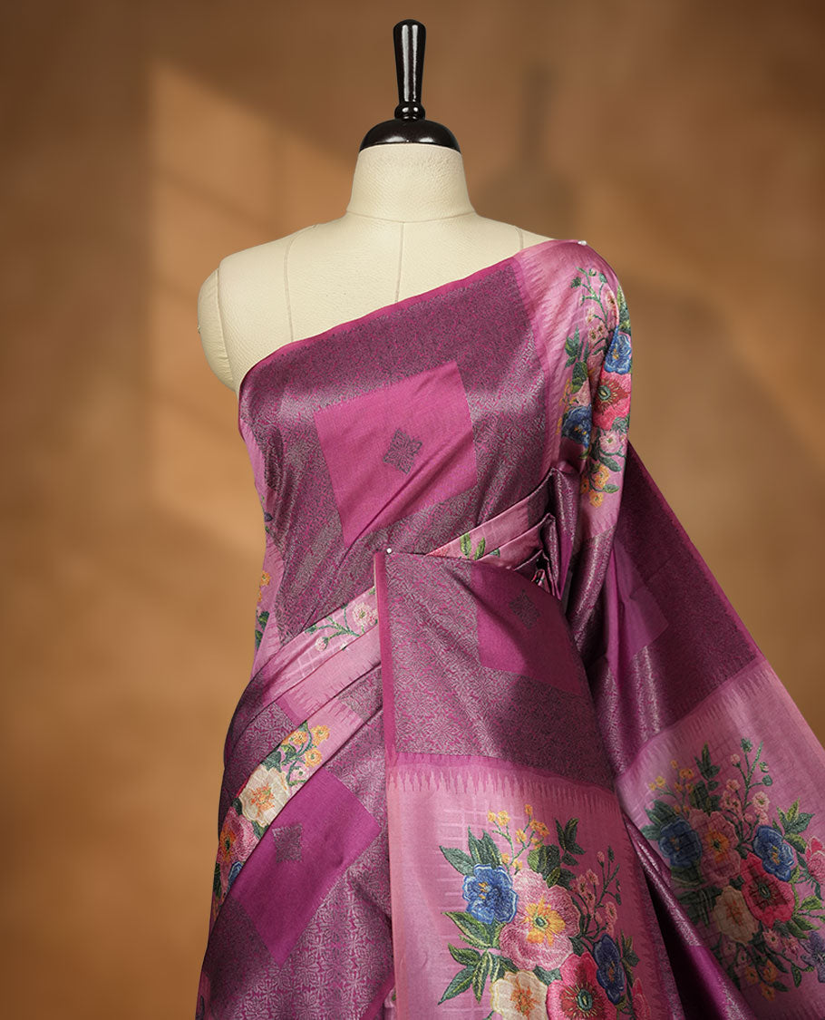Grape colour semi tussar Banarasi saree featuring vibrant multi-color floral prints across the body, with geometric zari patterns, and a matching blouse detailed with silver woven buttas.