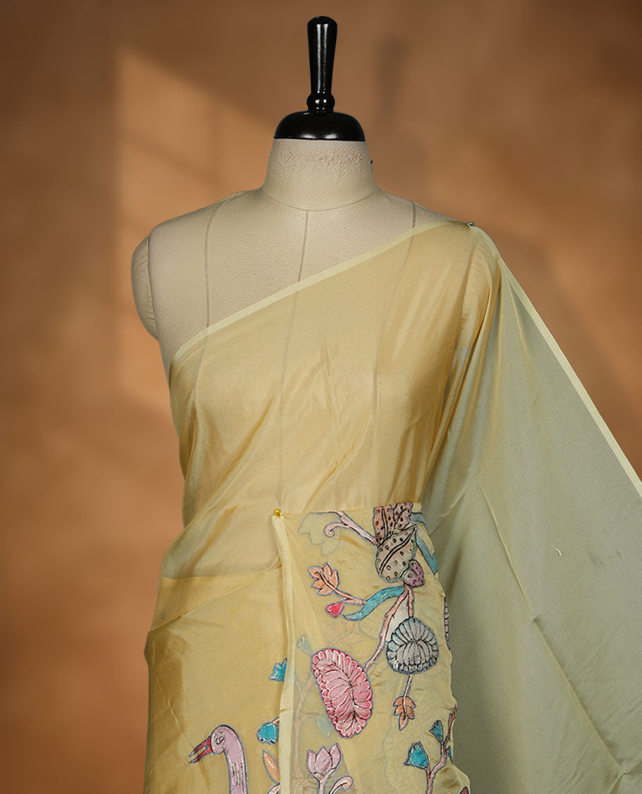Pastel yellow colour organza saree with multicolour thread embroidery on the pallu and fine border detailing, paired with a matching blouse.