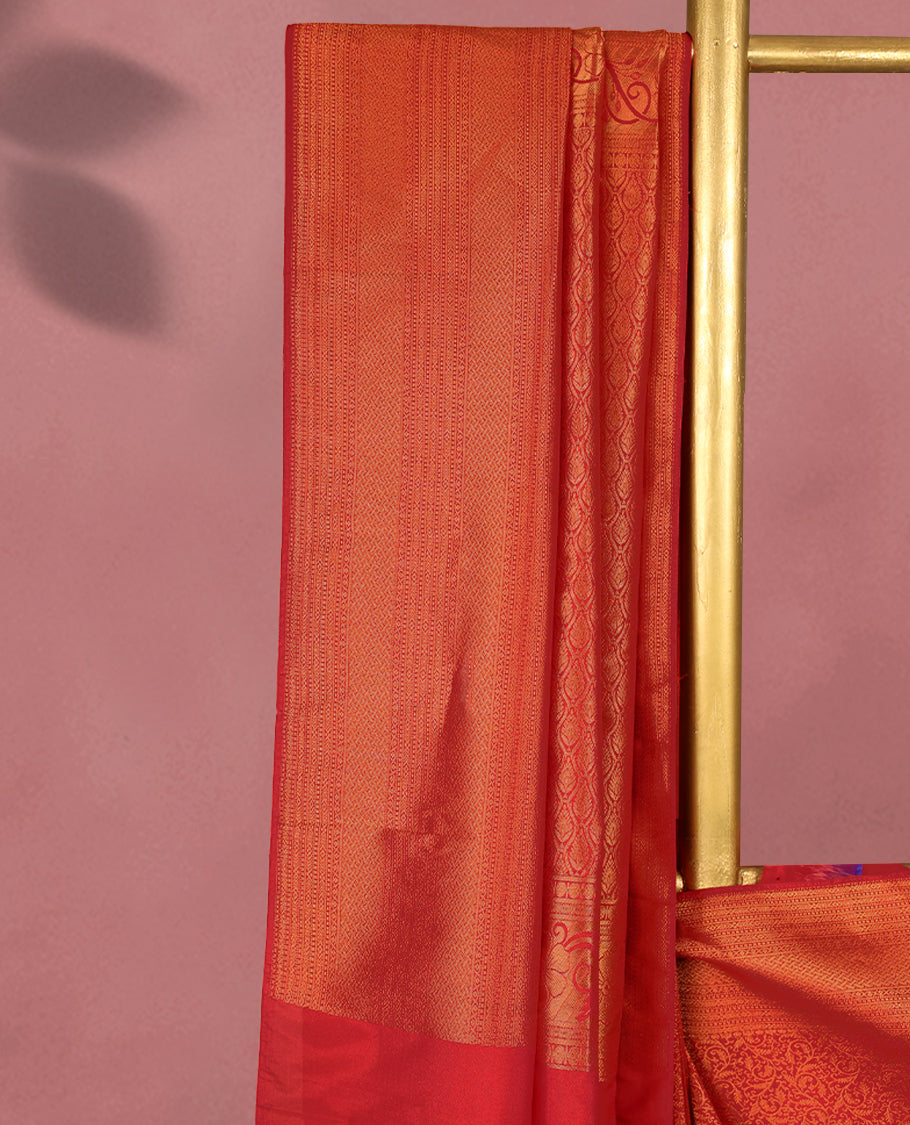 Chilli Red colour Kancheepuram saree featuring an antique zari brocade body, complemented by a traditional border and a matching blouse.