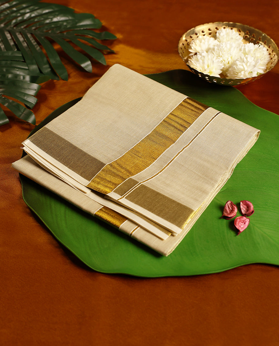 Golden beige pure handloom double dhoti featuring a broad shimmering golden zari border, crafted in a rich and elegant finish, perfect for weddings, festive wear, and traditional occasions.