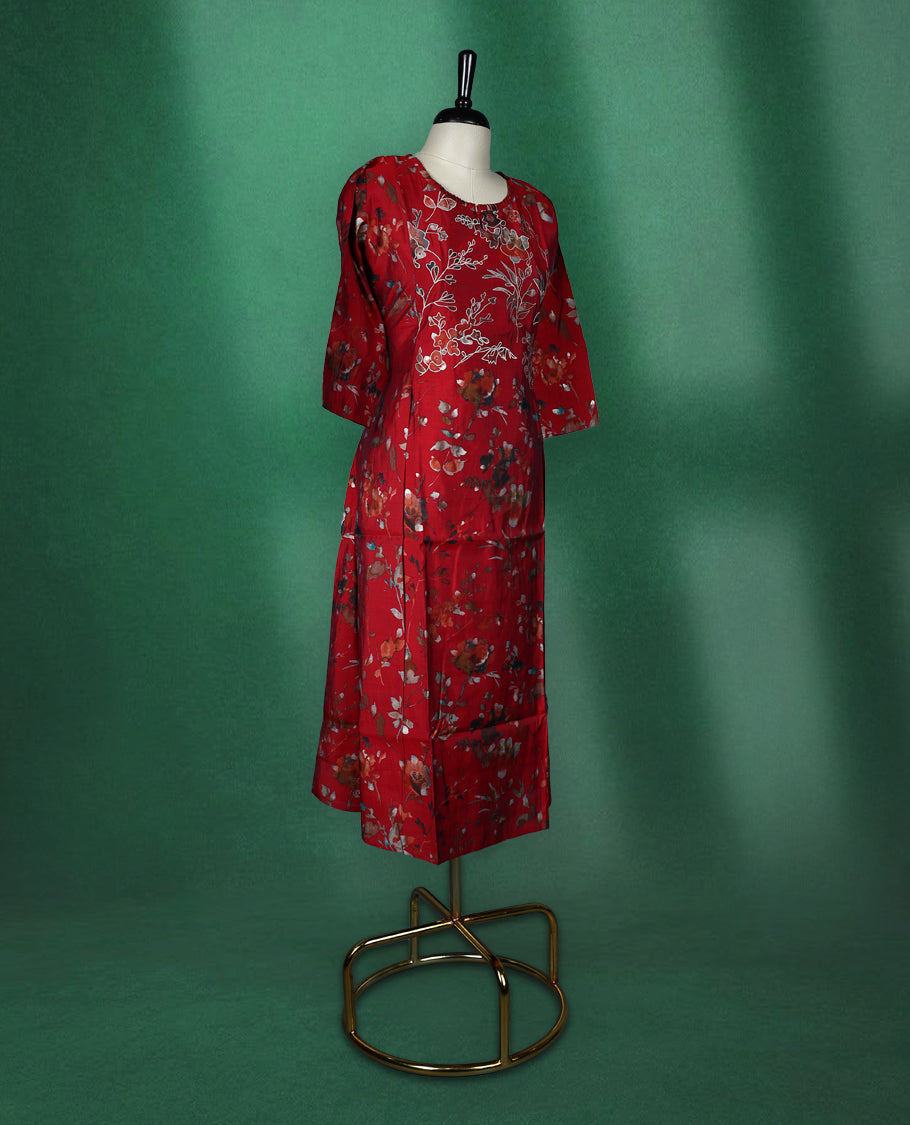 Elegant red kurti with all over floral print, styled with a round neckline, elbow length sleeves, and a straight cut silhouette perfect for casual or semi formal wear.