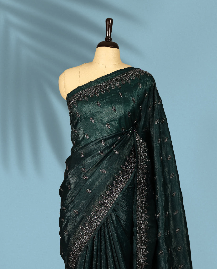 Deep Sea Green Colour crush soft silk saree, textured body with a natural crinkled finish, adorned with intricate Silver colored floral Motifs and complemented by a delicate Silver Zari embroidery border, paired with a matching blouse