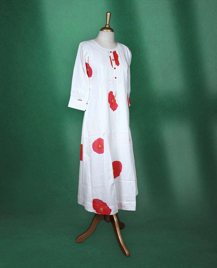 White colour A line kurti featuring a round neck with front pleated detailing, three quarter sleeves, and bold red floral prints for a fresh and elegant look.