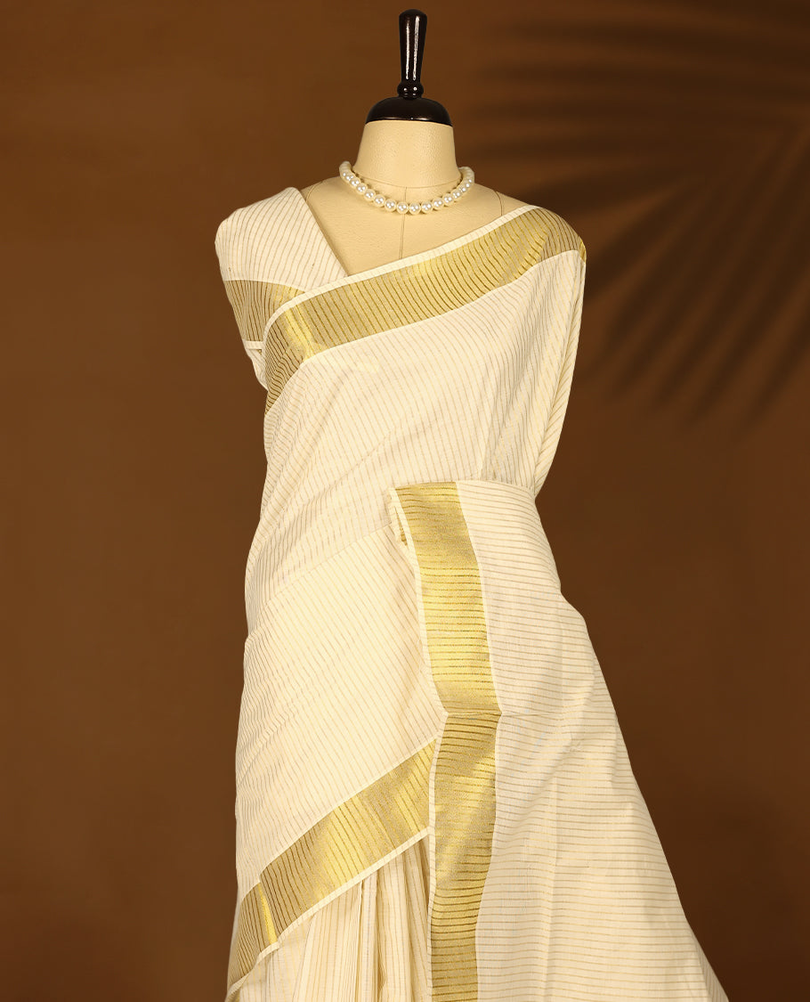 Kerala cotton saree with fine golden stripes and a Golden lustrous zari border with Matching Blouse