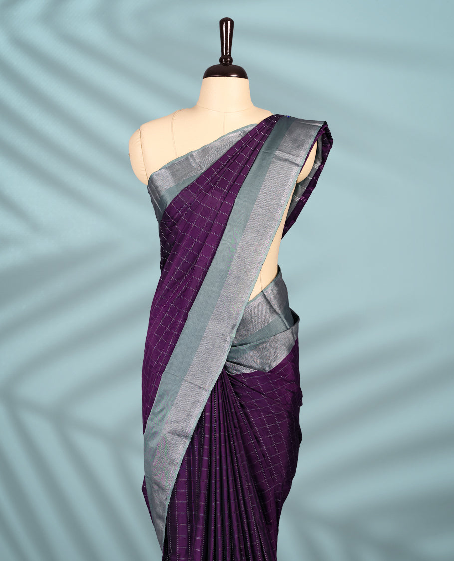 Regal purple Colour semi silk saree showcases a delicate silver zari check pattern, paired beautifully with a contrasting Ash Green border and a matching blouse