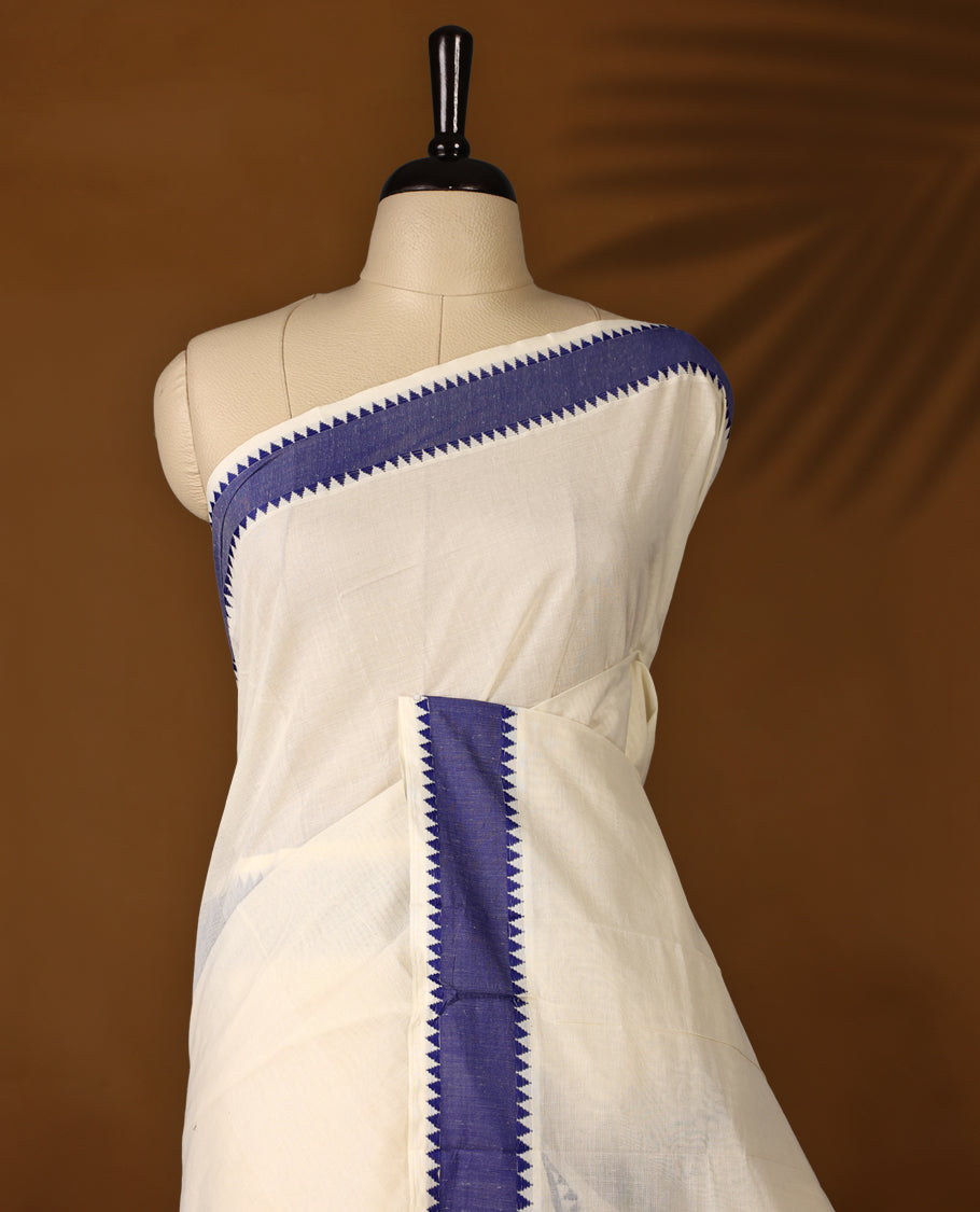 Elegant off white colour cotton Kerala saree featuring Plain body, Blue colour border with Peacock Motifs, Paired with matching blouse offering a classic and graceful look, paired with a matching blouse.
