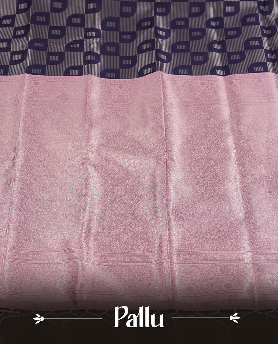 Navy blue colour semi silk saree adorned with silver zari motifs on the body, complemented by a pastel pink pallu intricately woven with rich floral patterns border and pallu, and paired with a matching blouse