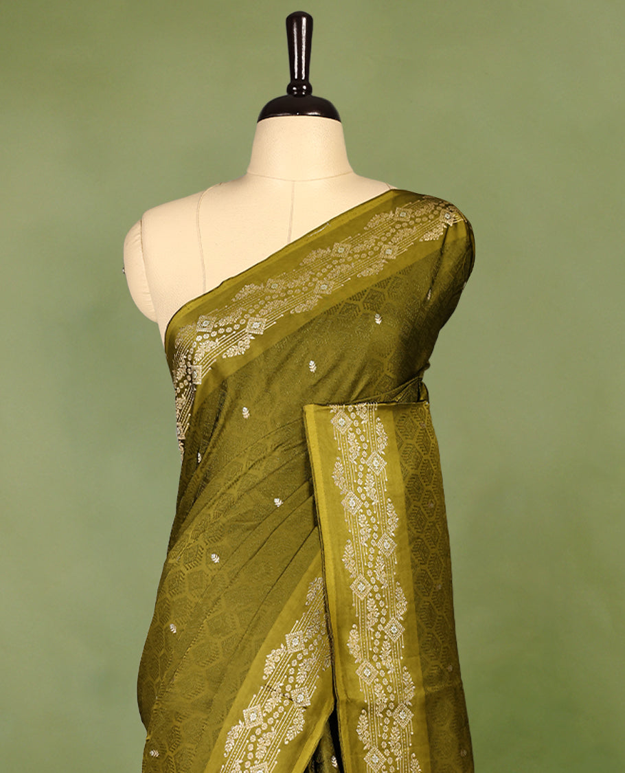 Olive Green colour pure Banaras crepe saree showcases elegant Gold & Silver zari Motifs all over the body, a traditional gold & Silver zari border, a rich intricately woven pallu, and comes with a matching blouse.