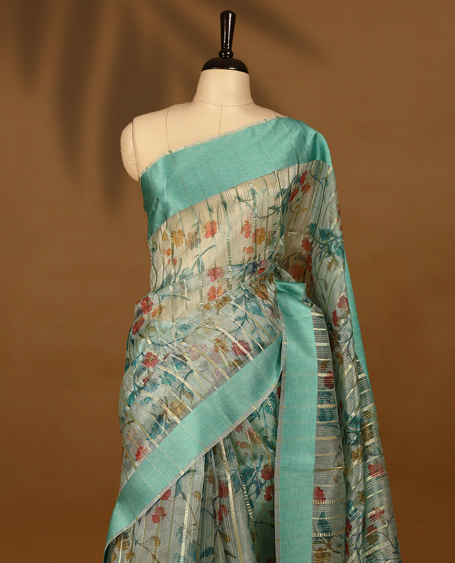 Light aqua semi-organza saree with intricate floral jaal work, elegant border, and a matching silk brocade blouse.