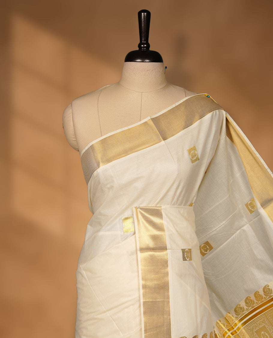 Elegant Off white colour cotton Kerala saree with gold zari buttas, broad kasavu border, and richly woven traditional pallu, paired with a matching blouse