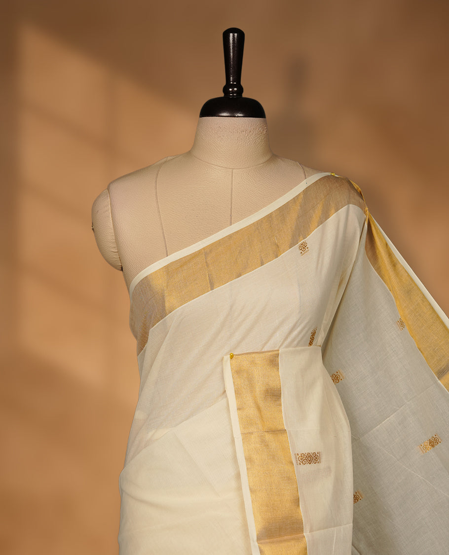 Elegant Off white colour cotton Kerala saree with gold zari buttas, broad kasavu border, and richly woven traditional pallu, paired with a matching blouse