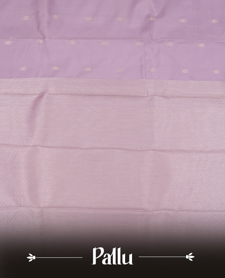 Lavender colour semi soft silk saree featuring a golden textured patterned body, complemented by self coloured golden traditional motifes on pallu & border and a matching blouse piece.