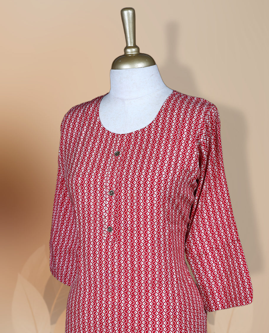 Maroon colour kurti featuring a round neckline with button detailing, 3/4th sleeves, and an all over geometric print in red and beige, designed in a straight cut silhouette for a simple and elegant everyday look.