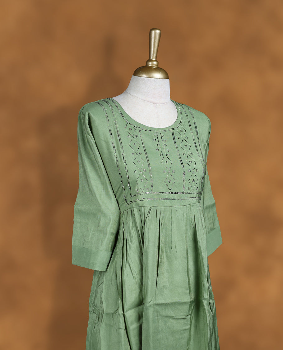 Pastel green colour kurti with styled with a stone pattern around neckline, knee length design, and a sleeve .