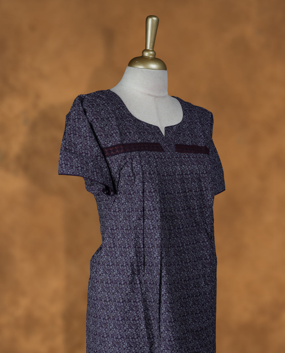 Dark purple colour NStyle nighty featuring gray floral patterns, a round neckline with spilt V, short sleeves, and a full ankle-length design.