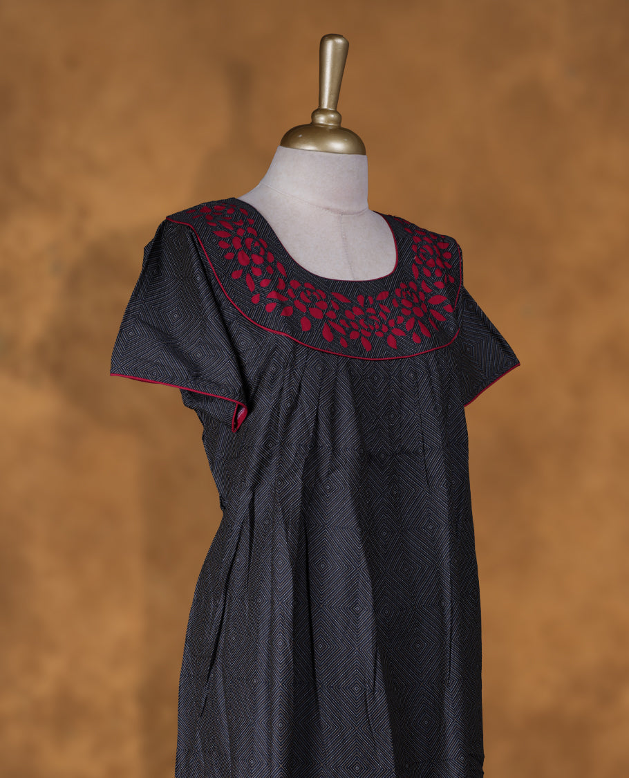 Black colour NStyle nighty featuring white geometric pattern, red colour floral patterns on a U neckline with red colour pipe details , short sleeves, and a full ankle-length design.