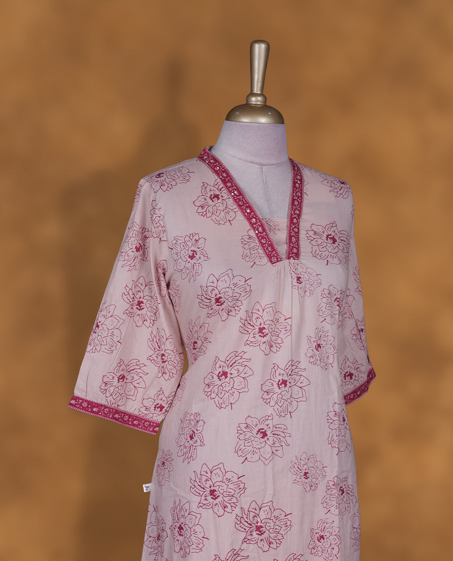 Baby pink colour kurti By Vismay styled with a thread pattern around neckline, print pattern across body knee length design, and a sleeve .