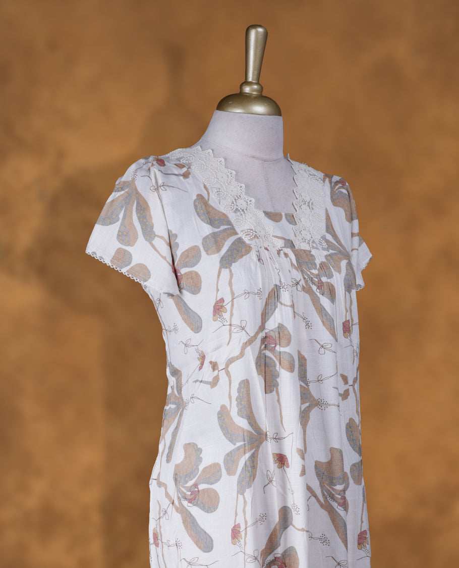 White colour NStyle nighty featuring brown floral patterns, a V neckline with lace detailing, short sleeves, and a full ankle-length design