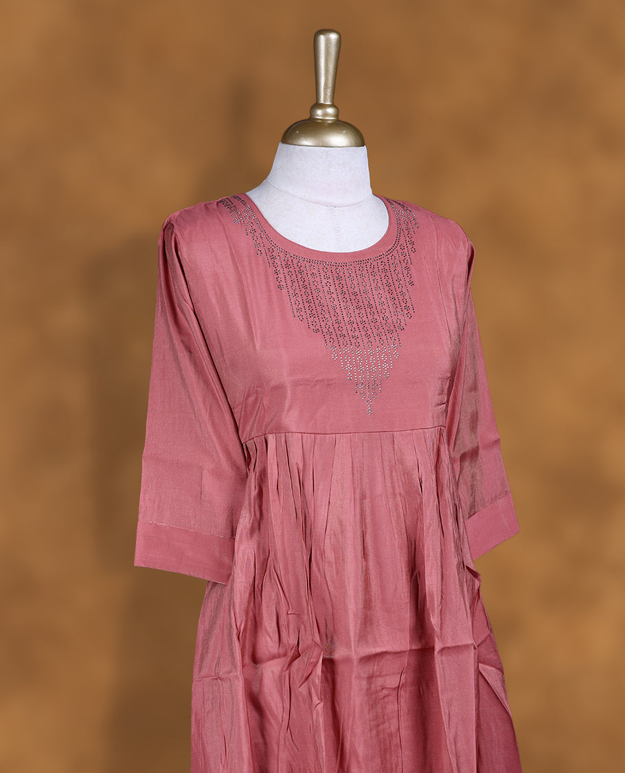 Peach colour kurti with white stone pattern, knee length design, styled with a Round neckline and a sleeve .