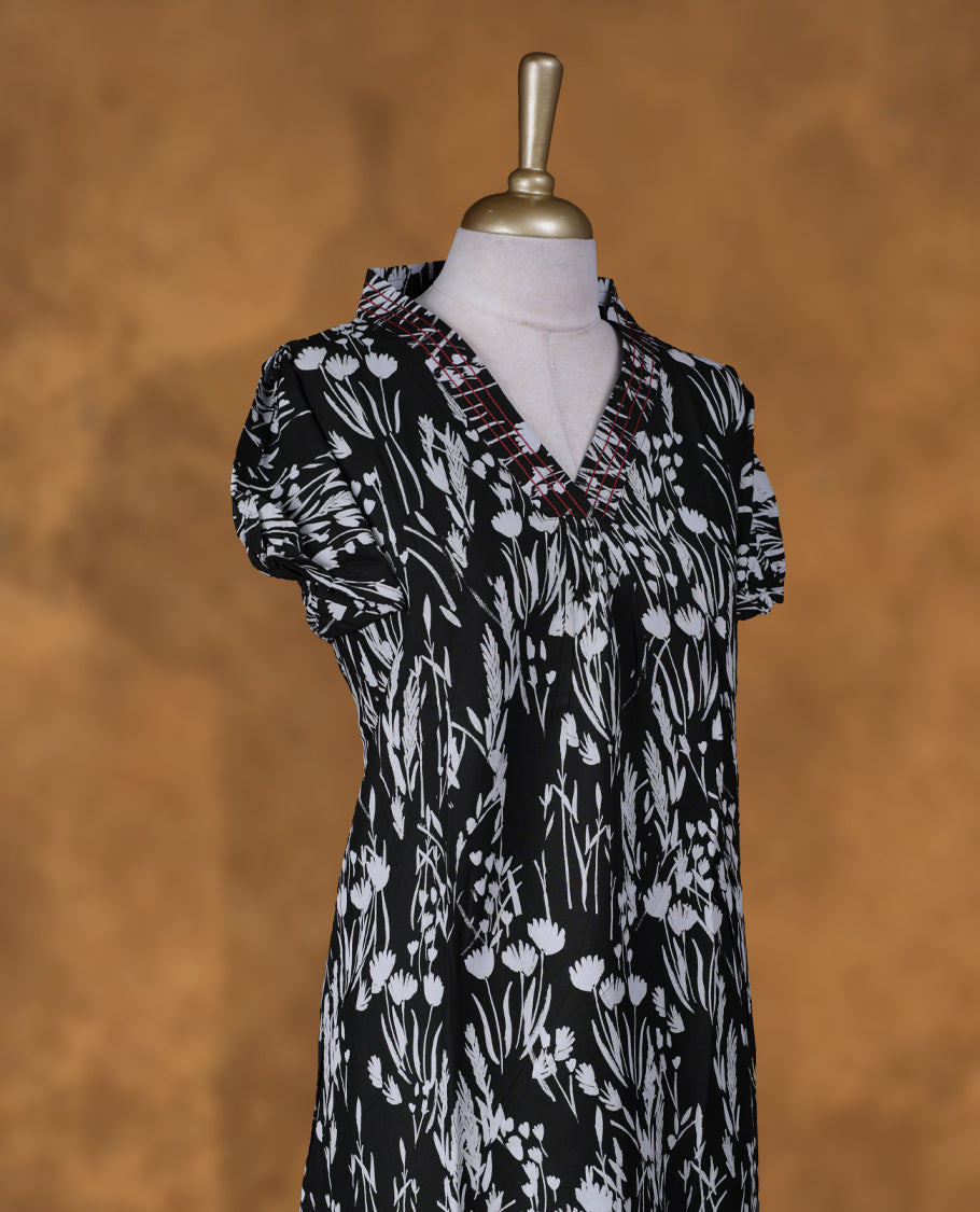 Black colour NStyle nighty featuring White floral patterns, a V neckline with thread pattern, short sleeves, and a full ankle-length design.